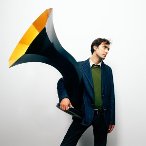 Andrew Bird, holding a Victrola.