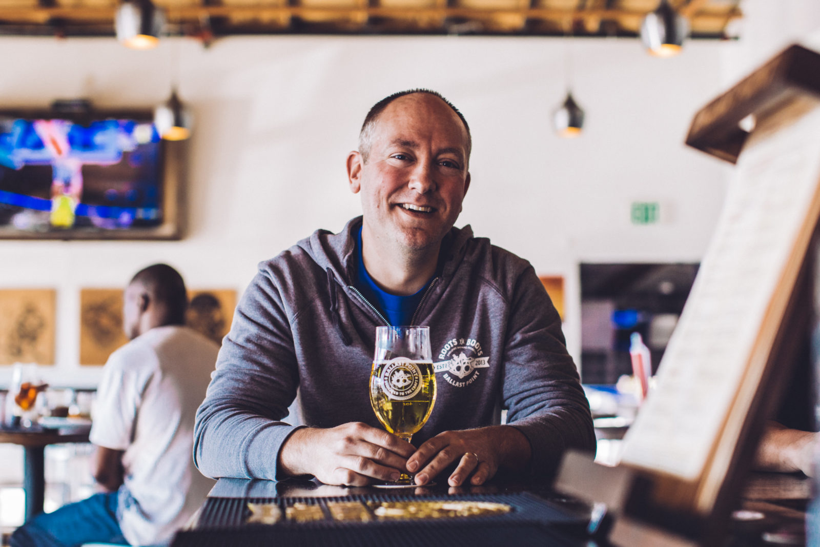 Ballast Point brewer Chris Hotz sits with a beer